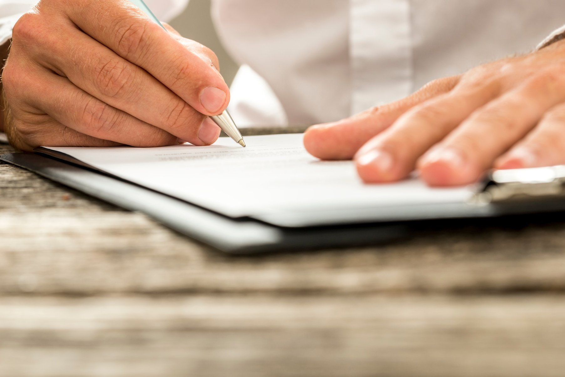 Low Angle View of Male Hand Signing Contract or Subscription for